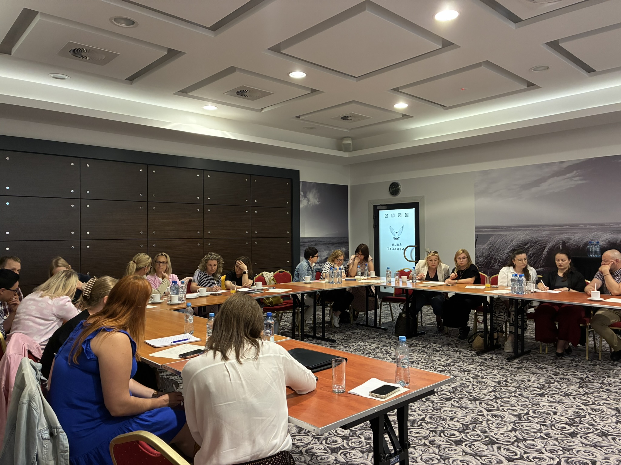 Grupa ludzi przy półokrągłym stole