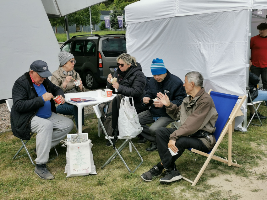 Pięć osób siedzi i je lody