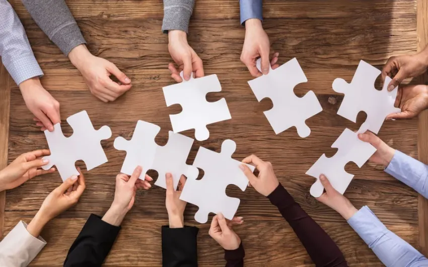 stó, dłonie trzymające puzzle 